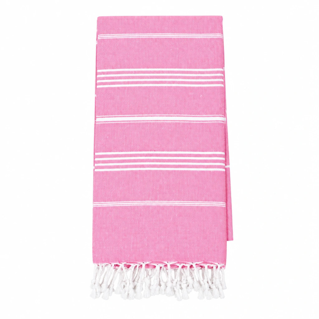 A pink Turkish cotton towel with white stripes and fringed edges, laid flat on a white background.
