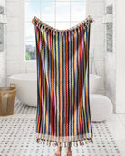 Colorful striped towel hanging in a bathroom